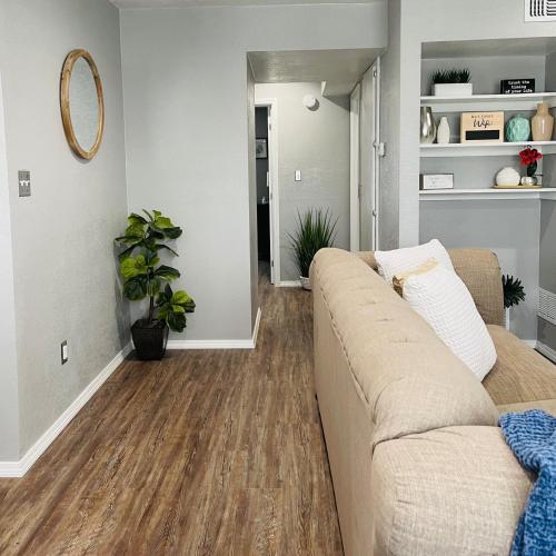 a living room with a couch and a hard wood floor at OU-2 bed 2 bath apartment close to OU in Oklahoma City