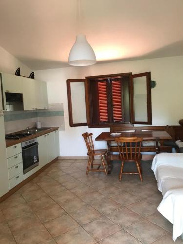 a kitchen and dining room with a table and chairs at Via Genova 1480 in San Teodoro