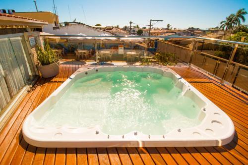 a hot tub on the deck of a house at Rede Andrade Terra Brasil in Porto Seguro