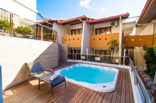a balcony with a swimming pool on a building at Rede Andrade Terra Brasil in Porto Seguro