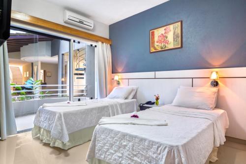 En eller flere senge i et værelse på Hotel Porto Napolis