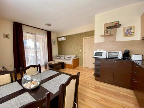 a living room with a dining table and a kitchen at Sozopol Harmani Beach Apartment 10 in Sozopol