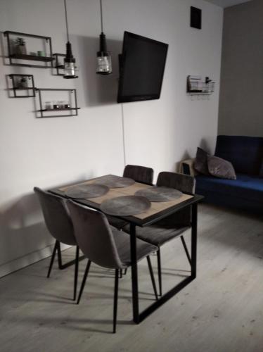 トルンにあるSiódemkaのソファ付きの客室で、テーブルと椅子が備わります。