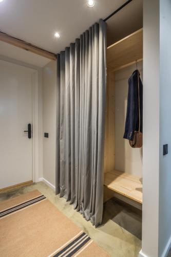 a walk in closet with gray curtains and a door at B2 Apartments in Klaipėda