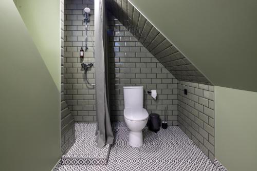 a bathroom with a toilet in a shower stall at B2 Apartments in Klaipėda