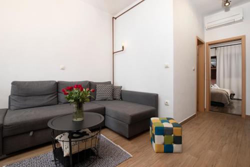 a living room with a couch and a table at Apartments Ingrid in Pula