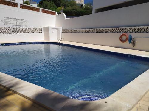 a swimming pool with blue water in a building at Casa Marc in Carvoeiro