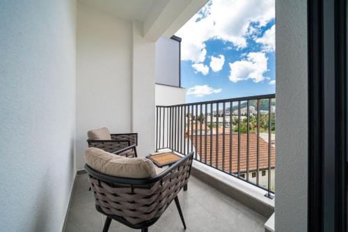 a balcony with a chair and a view of a building at Hotel Millennium by Aycon in Budva