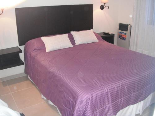 a purple bed with two pillows on top of it at Complejo Ayenué & Spa II in Ostende