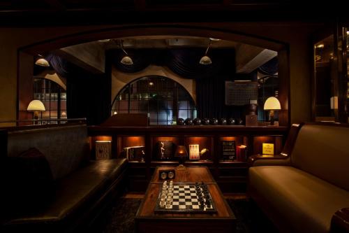 a living room with a chess board on a table at The Hollywood Roosevelt in Los Angeles