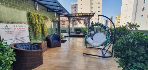 a balcony with a swing on a building at Hotel das Américas in Balneário Camboriú