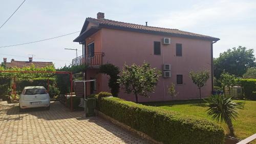 a small car parked in front of a house at App Sabolic in Umag