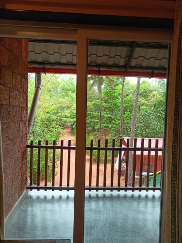 a view from a glass door of a porch at OmBodhi Retreat in Kumta