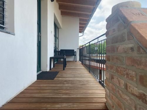 a balcony with a wooden floor and a brick wall at Penzion Lednice in Lednice