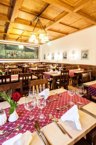a dining room with tables and chairs with wine glasses at Schlossrestaurant Neuschwanstein in Hohenschwangau