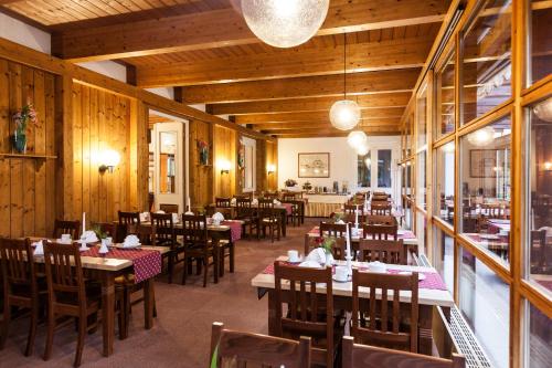 a restaurant with wooden walls and wooden tables and chairs at Schlossrestaurant Neuschwanstein in Hohenschwangau