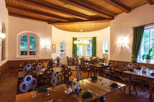 a restaurant with tables and chairs in a room at Schlossrestaurant Neuschwanstein in Hohenschwangau