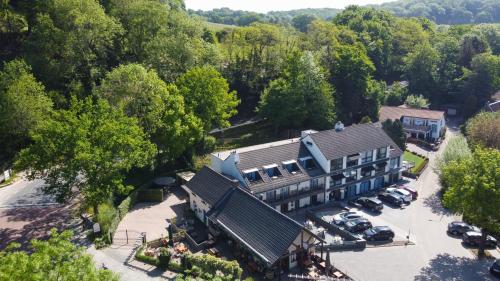 an aerial view of a large house with a parking lot at Hof van Slenaken - Hotel & Apartments in Slenaken