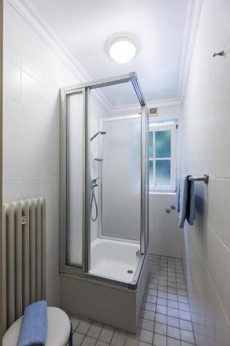 a bathroom with a shower and a toilet at Schlossrestaurant Neuschwanstein in Hohenschwangau
