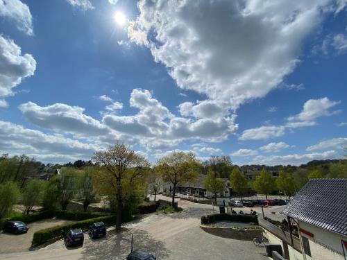 a cloudy sky with cars parked in a parking lot at Hof van Slenaken - Hotel & Apartments in Slenaken