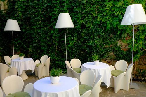 a group of tables and chairs with lights on them at Petronilla - Hotel In Bergamo in Bergamo