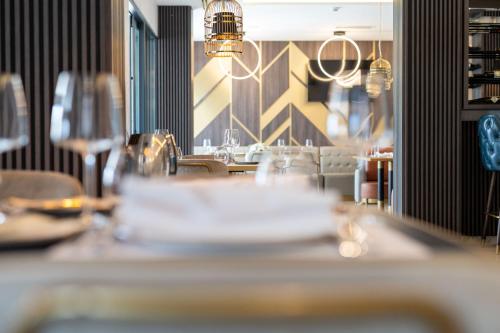a restaurant with a table with glasses on it at Hotel Millennium by Aycon in Budva