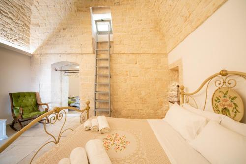a bedroom with a bed and a brick wall at Trullo Antica Bellezza in Alberobello