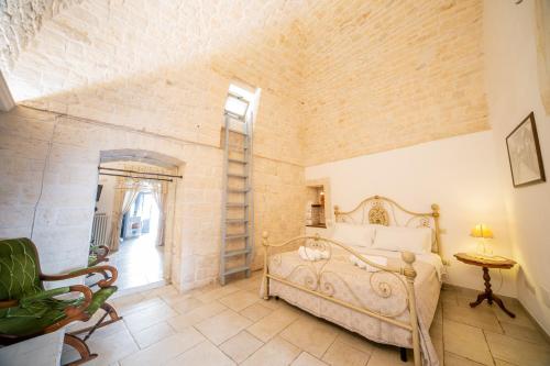 a bedroom with a bed and a brick wall at Trullo Antica Bellezza in Alberobello