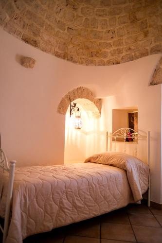 a bedroom with a bed with a stone ceiling at TRULLO ELVIRA & LUIGI in Monopoli