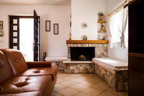 a living room with a fireplace and a couch at TRULLO ELVIRA & LUIGI in Monopoli
