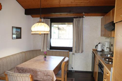 a kitchen and a table in a small room at Ferienhaus Robinson Schinderhanneseck 112 in Waldbrunn