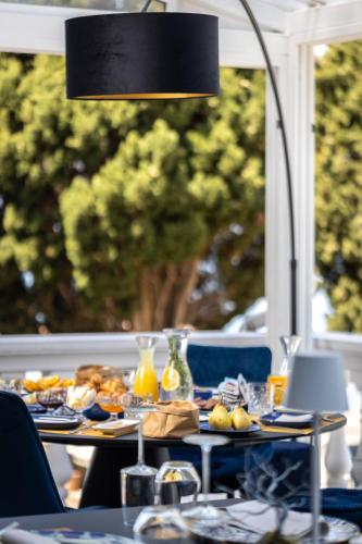 a table with plates of food and a lamp at Villa Valdepian Apartments in Savudrija