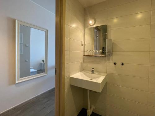 a bathroom with a sink and a mirror at Aisa Studio in Pärnu