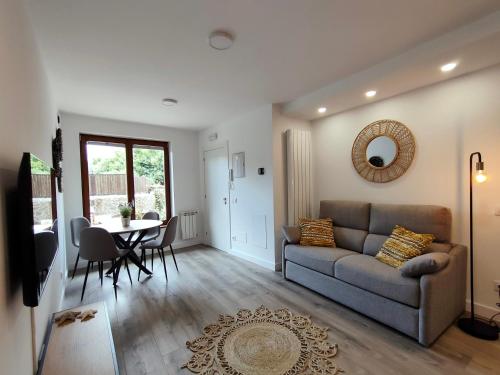 a living room with a couch and a table at Salitre en el Cuera in Llanes