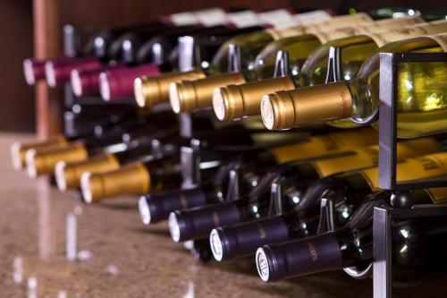 a row of wine bottles on a table at Ayres Hotel & Spa Mission Viejo - Lake Forest in Mission Viejo