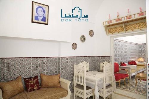 a living room with a couch and a table at Dar Tata in Nabeul
