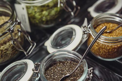a table topped with jars of seeds and jars of food at Lagoas Park Hotel in Oeiras