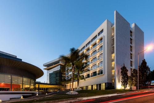 a large white building on a city street at night at Lagoas Park Hotel in Oeiras
