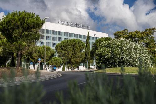 a white building with a sign on top of it at Lagoas Park Hotel in Oeiras