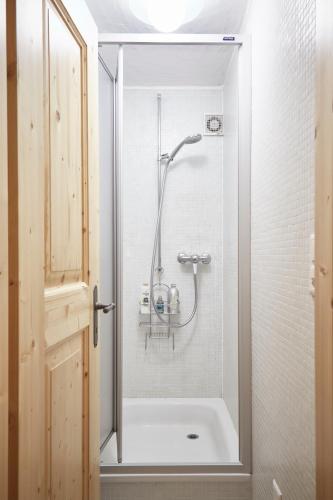 a shower in a bathroom with a glass door at Roux in Grimentz