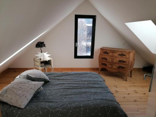 sypialnia z łóżkiem i drewnianą podłogą w obiekcie Maison dans parc clôturé w mieście Barcelonnette
