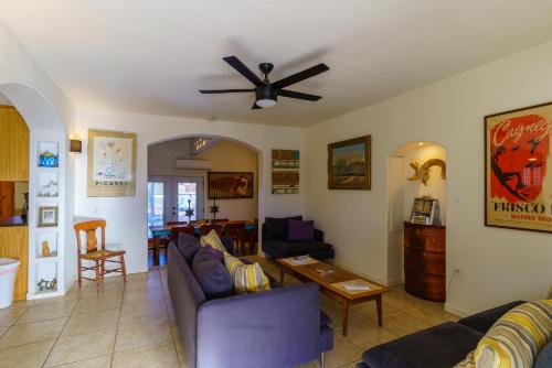 a living room with couches and a ceiling fan at Flying Point Homestead in Twentynine Palms