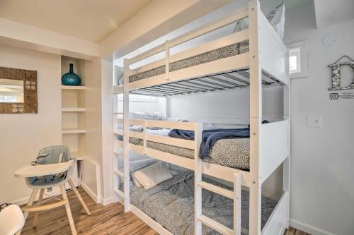a room with bunk beds with a desk and a chair at Rockaway Beach Condo - Beach Access Nearby! in Rockaway Beach