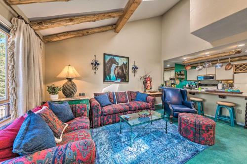 a living room with a couch and a table at Eclectic Home with Deck 4 Miles to Ski Cloudcroft! in Cloudcroft