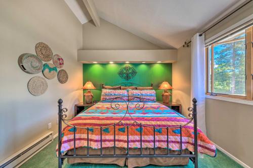 a bedroom with a bed and a green wall at Eclectic Home with Deck 4 Miles to Ski Cloudcroft! in Cloudcroft