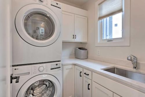 a white laundry room with a washer and a sink at Traverse City Townhome Walk to Beach! in Traverse City