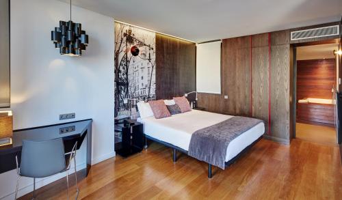 a bedroom with a bed and a desk in it at Sercotel Hotel Rosellon in Barcelona