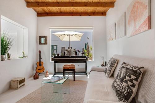 a living room with a couch and a piano at La Casa de Petrita in Pájara