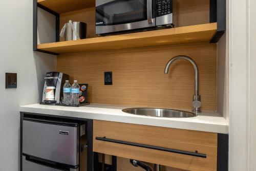 a kitchen with a sink and a microwave at Infinity Hotel San Francisco, Tapestry Collection by Hilton in San Francisco