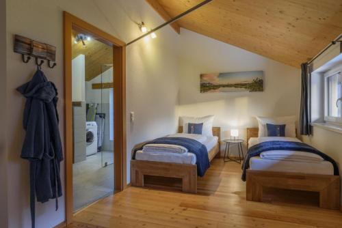 two beds in a small room with a mirror at Ferienlodge MaResi in Bad Goisern